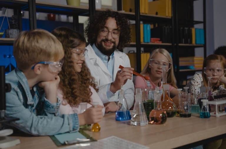 man doing science experiment with kids