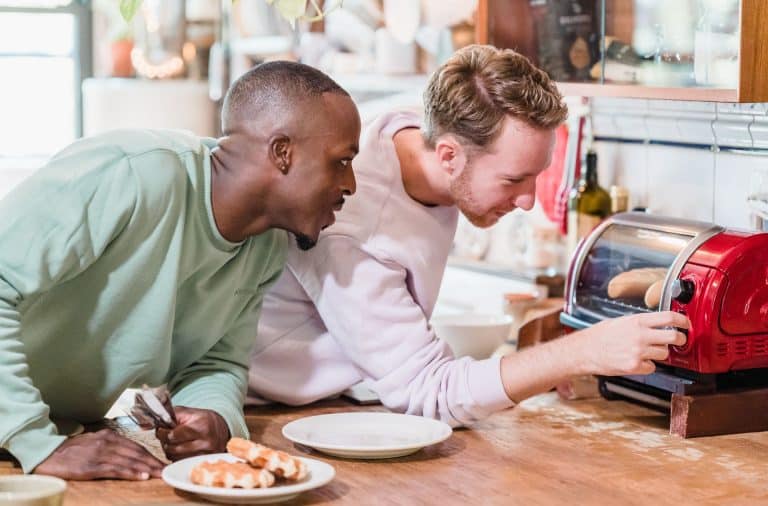men looking at toaster