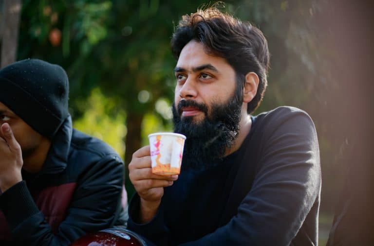 man drinking Dunkin
